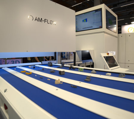 Four conveyor belts with parts feeding into machine